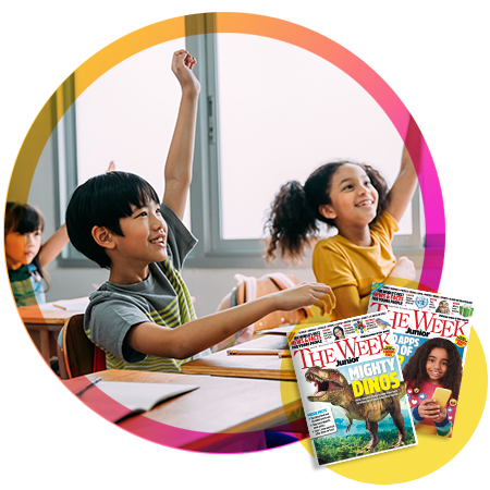 Two students raise their hands in a classroom